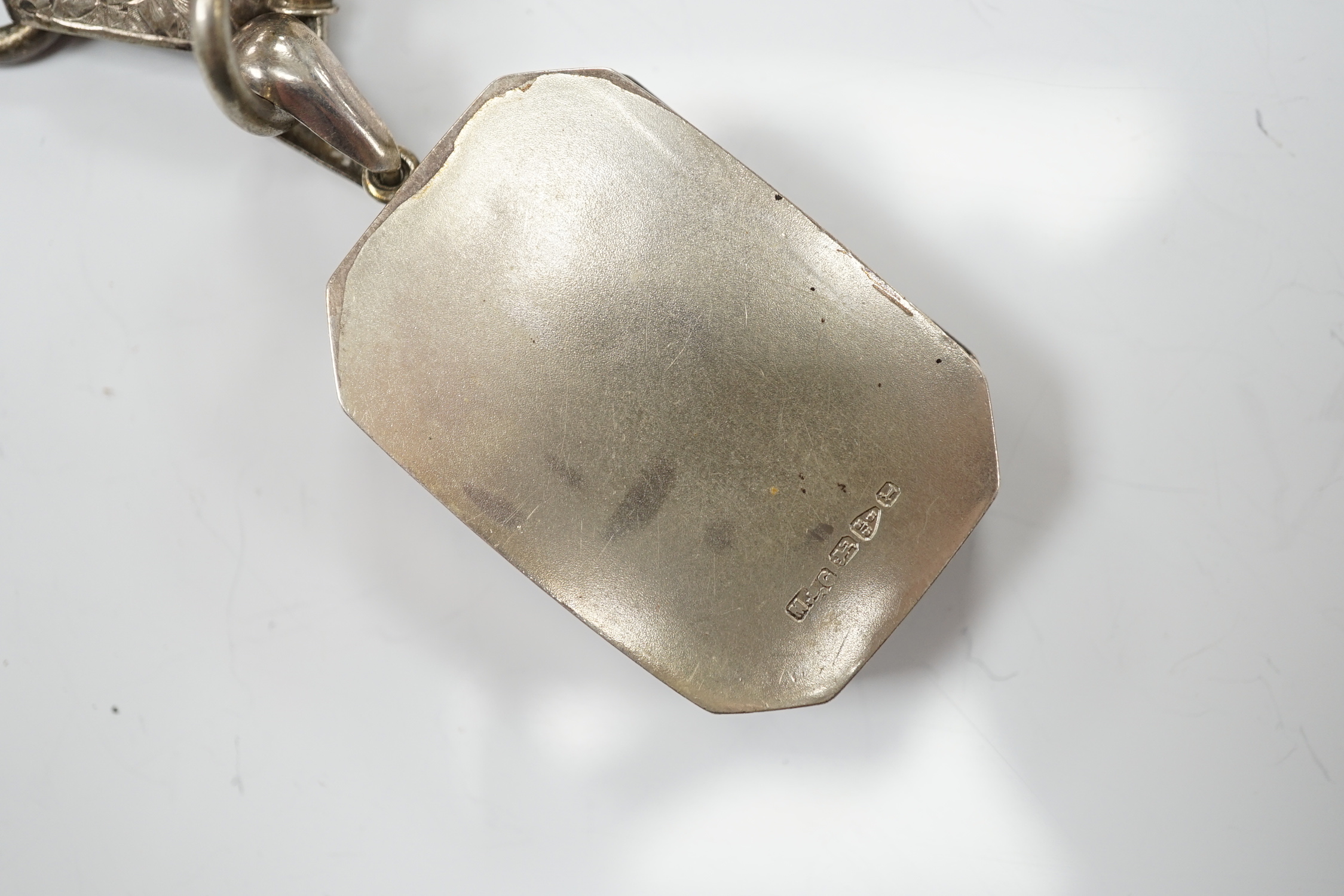 A Victorian silver octagonal locket, Chester, 1880, 44mm, on an engraved white metal chain.